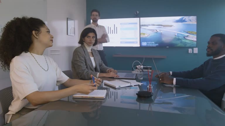 A team discussing a presentation in a meeting room